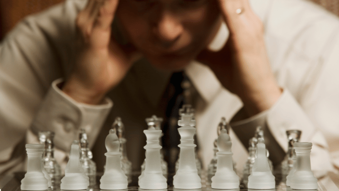 Man Starting at Chess Table Contemplating Next Move | The Power of Attention