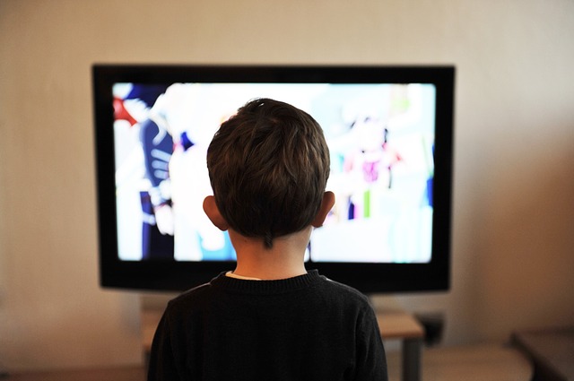 boy looking at TV | how to stop being passive, how to stop being a passive person